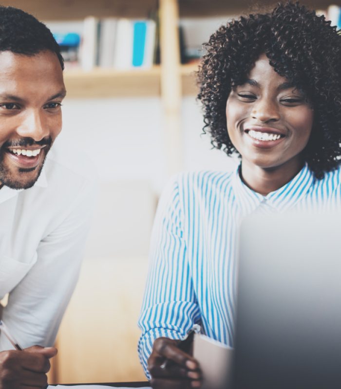 Two,Young,Coworkers,Working,Together,In,A,Modern,Office.african,Black